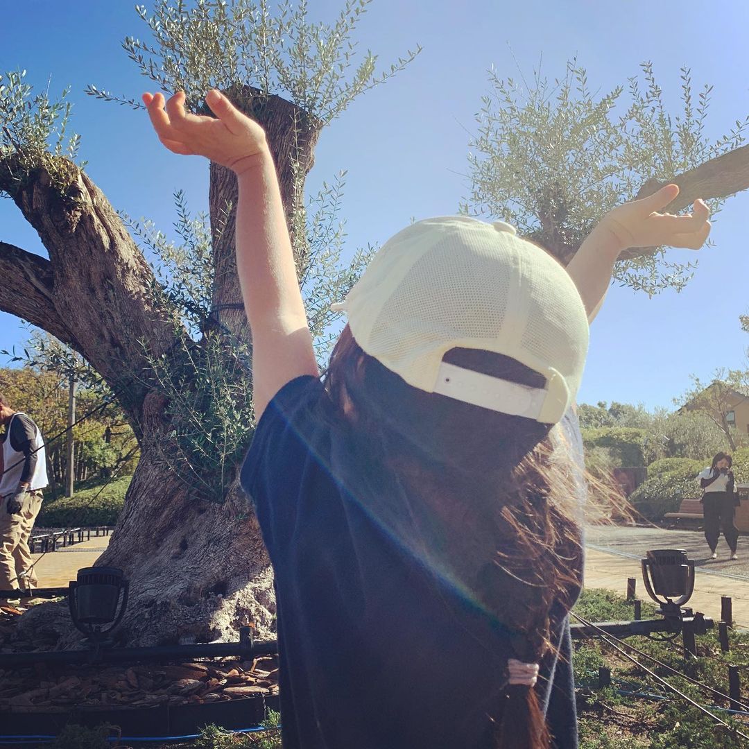 child with old olivetree